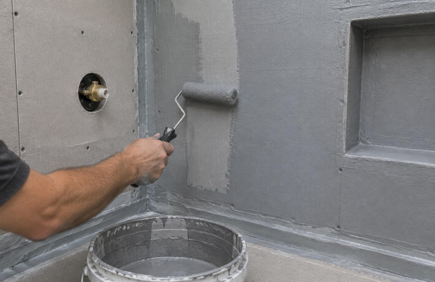 Waterproofing membrane being applied to a shower wall before tiling